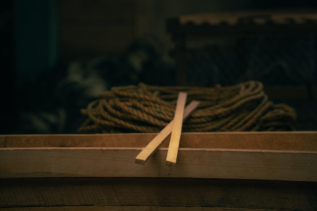 Split wooden laths used in lobster trap construction for strength and durability