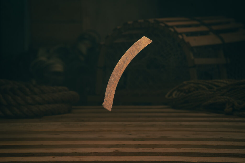 Curved wooden door cleat used in lobster trap construction for alignment and stability