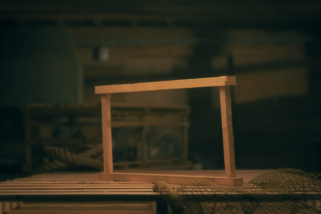 Wood cross sill structure connecting trap posts for lobster trap assembly